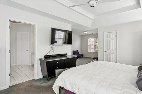 a bedroom with a bed and a flat tv screen
