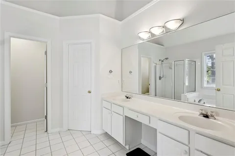 a bathroom with a double vanity sink mirror and
