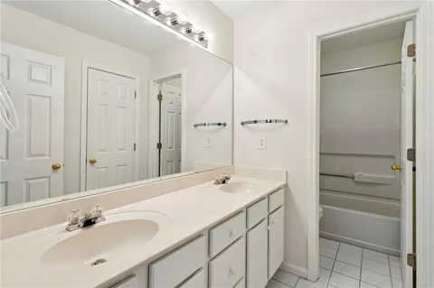 a bathroom with a shower sink and mirror