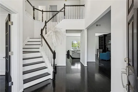 a view of entryway and hall with wooden floor