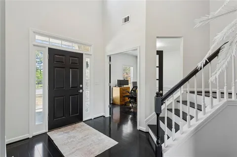 a view of entryway with wooden floor and stairs