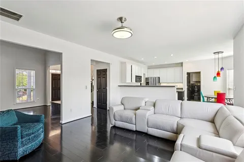 a living room with furniture and kitchen view