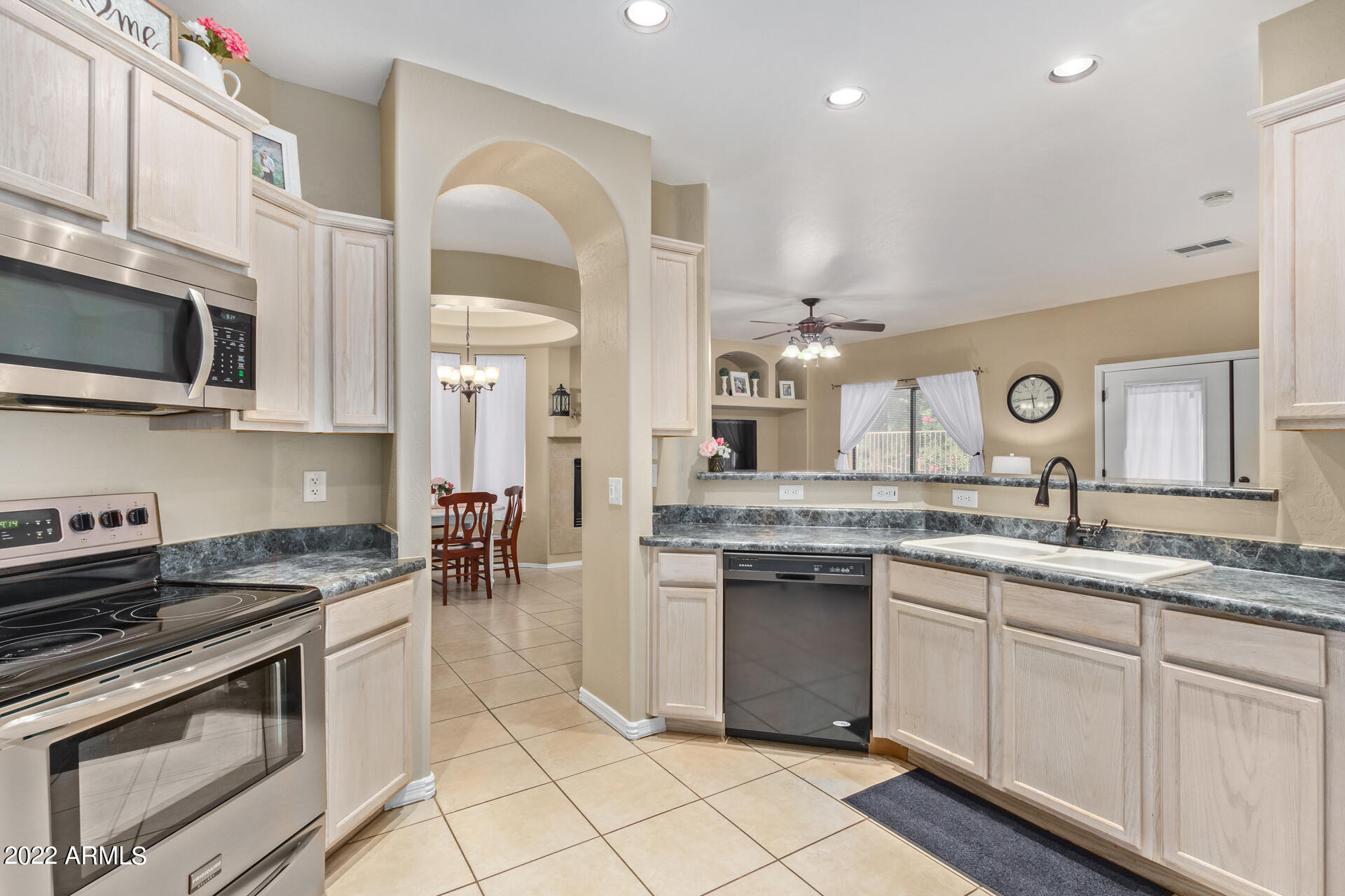 2565 South Signal Butte Road, Unit 47 Mesa, AZ 85209 - Photo 10 of 29 a kitchen with a sink stove and cabinets