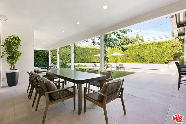 a view of a patio with a table and chairs