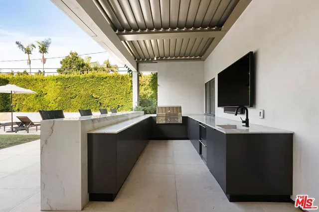 a kitchen with kitchen island a sink appliances and a large window