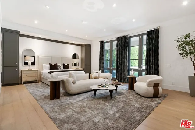 a living room with furniture and large windows