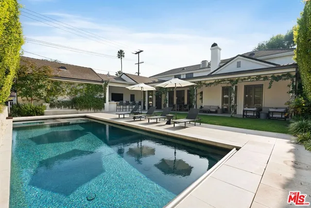 a view of a patio with swimming pool table and chairs