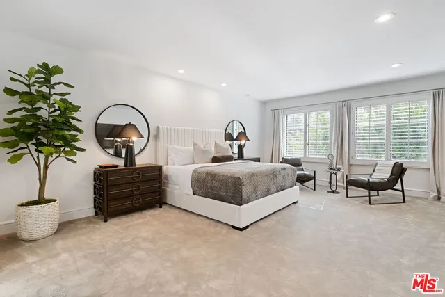 a bedroom with bed and a large window