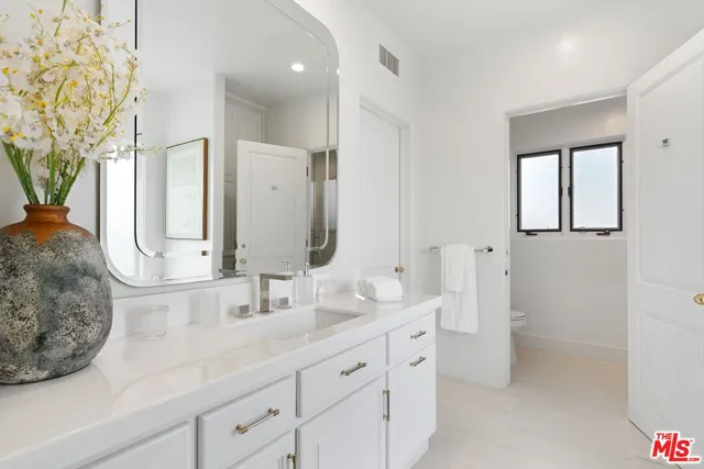 a bathroom with a double vanity sink and a mirror