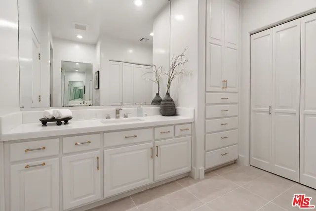 a bathroom with a double vanity sink and mirror