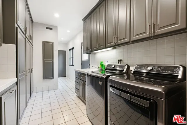 a kitchen with stainless steel appliances granite countertop a stove a refrigerator and a cabinets
