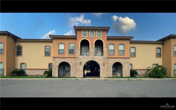 a view of a brick house with large windows