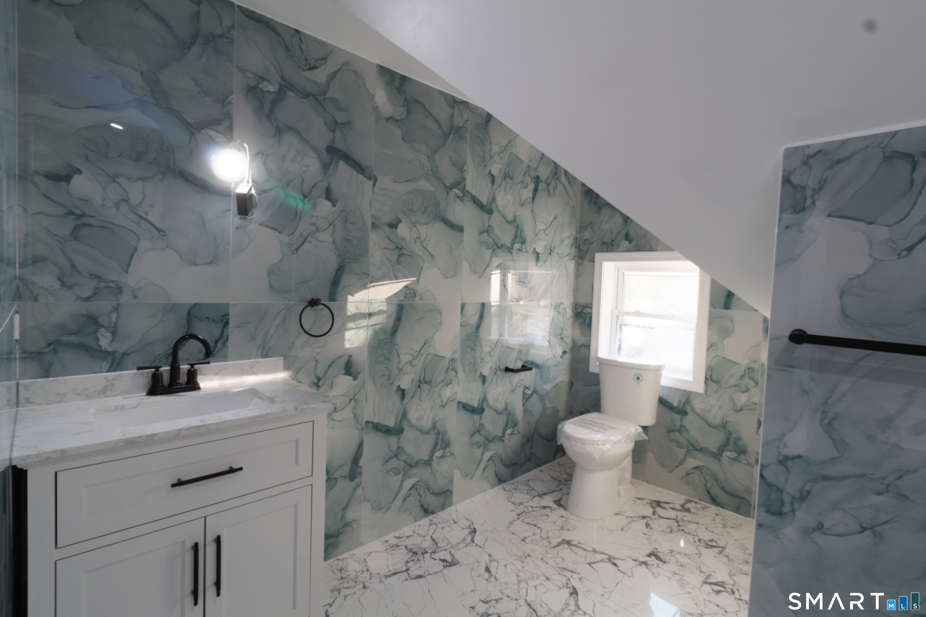 40 Elizabeth Street, Unit 3 Waterbury, CT 06704 - Photo 8 of 10 a bathroom with a sink toilet and shower