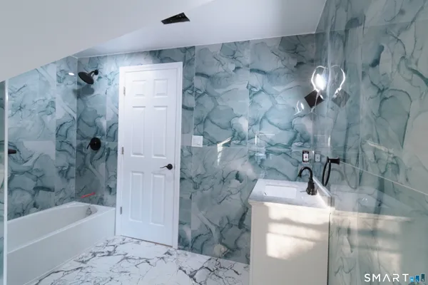 a bathroom with a bathtub and shower