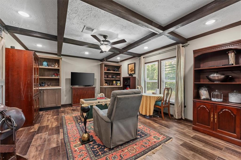 170 Anoia Road Washington, GA 30673 - Photo 11 of 46 a living room with furniture a flat screen tv and a rug