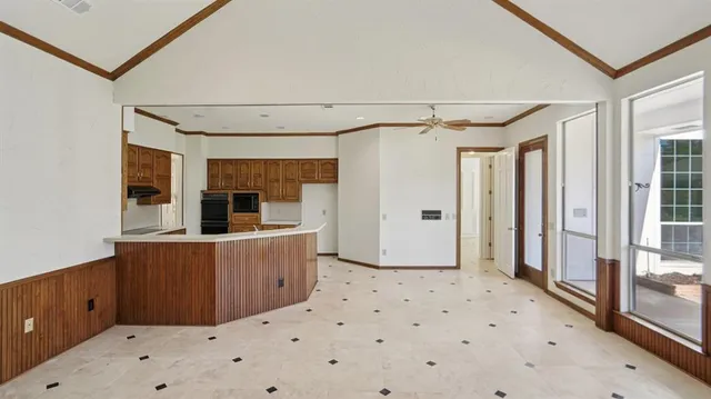 a kitchen with granite countertop a refrigerator and a sink