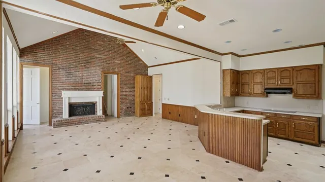 a view of a kitchen with a sink and a refrigerator