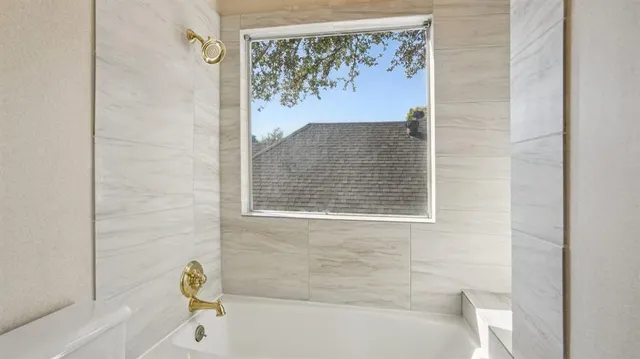 a bathroom with a bathtub and a shower