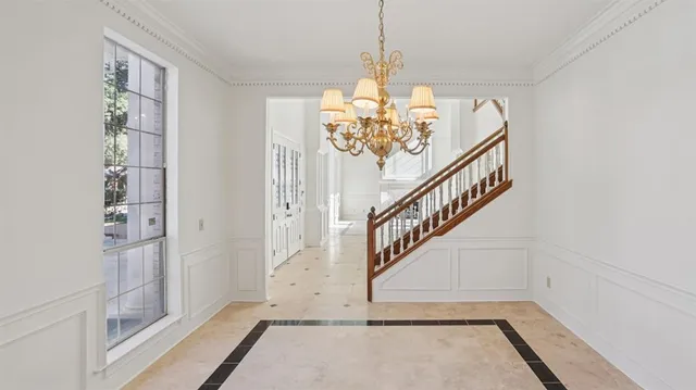 a view of a livingroom with wooden floor and stairs