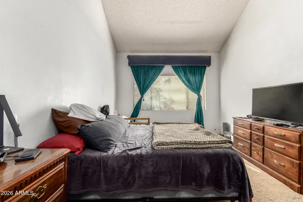 a bedroom with a bed a books and cabinets