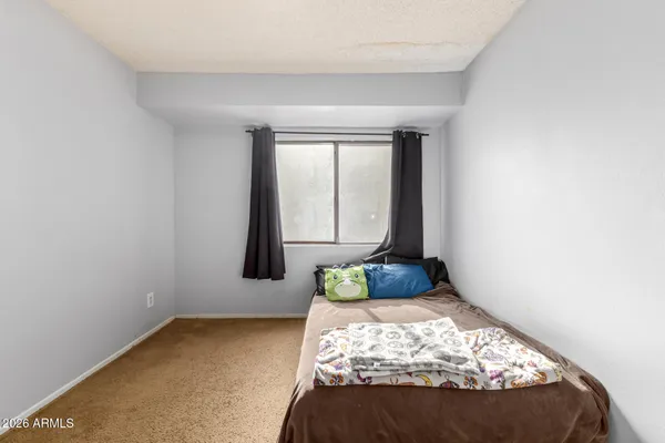 a bedroom with a bed and window