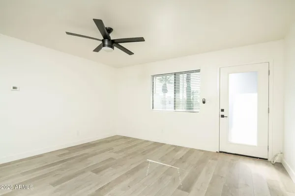 a view of a livingroom with a ceiling fan and wooden floor
