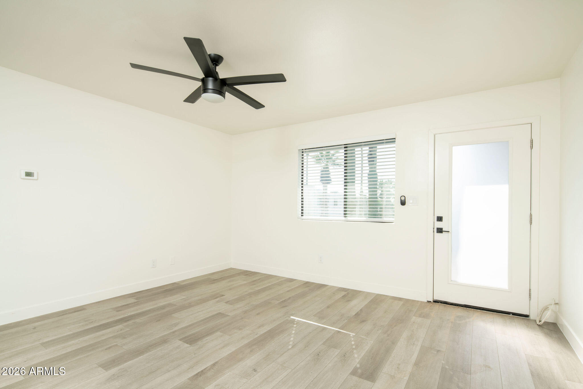 4119 North 11th Avenue Phoenix, AZ 85013 - Photo 16 of 28 a view of a livingroom with a ceiling fan and wooden floor