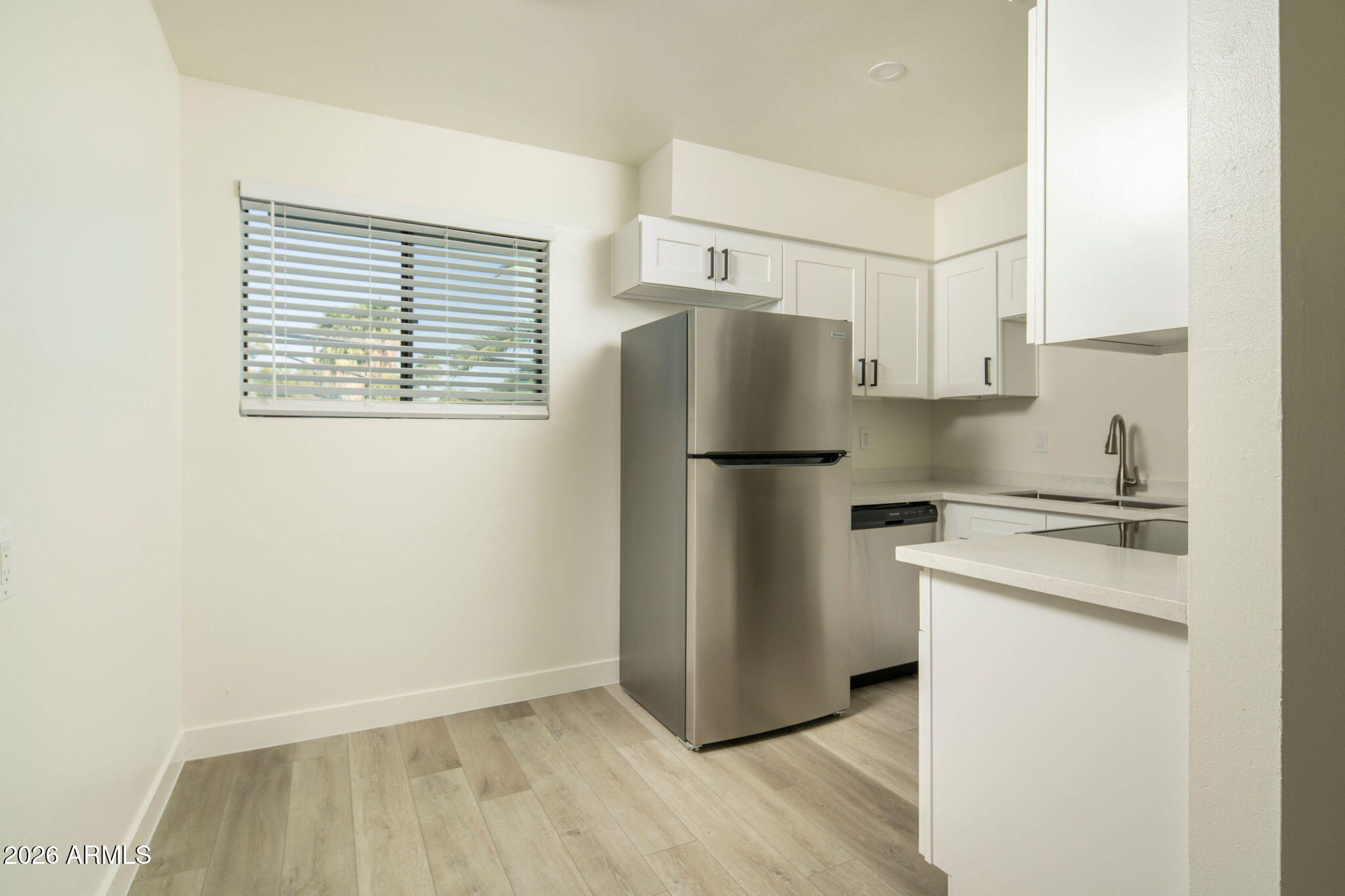 4119 North 11th Avenue Phoenix, AZ 85013 - Photo 19 of 28 a kitchen with a refrigerator a stove and a cabinets