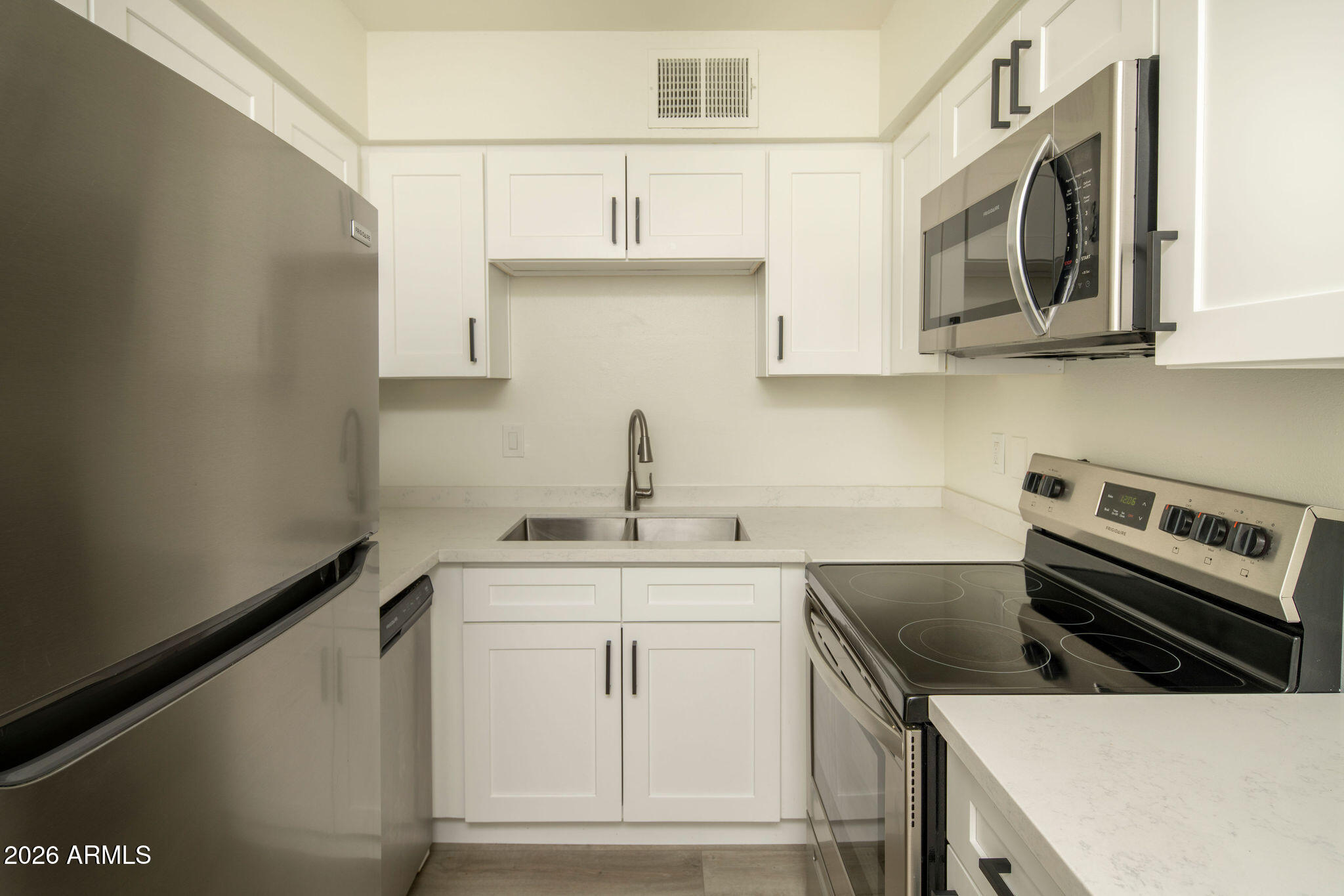 4119 North 11th Avenue Phoenix, AZ 85013 - Photo 20 of 28 a kitchen with stainless steel appliances granite countertop a sink stove and microwave