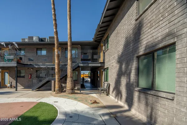 a view of a house with a patio and a yard