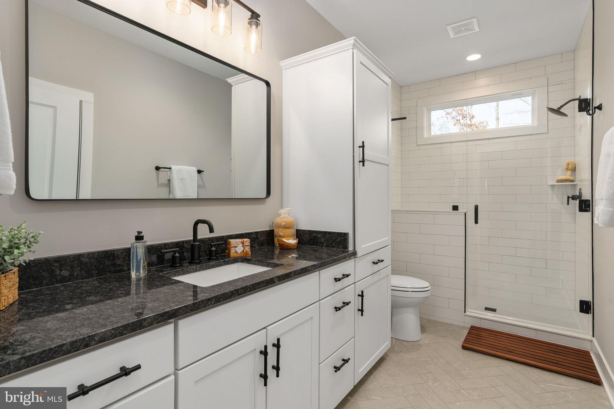 261 Washington Street Locust Grove, VA 22508 - Photo 37 of 69 a bathroom with double sink and a mirror