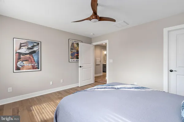 an aerial view of green landscape with trees houses and lake view