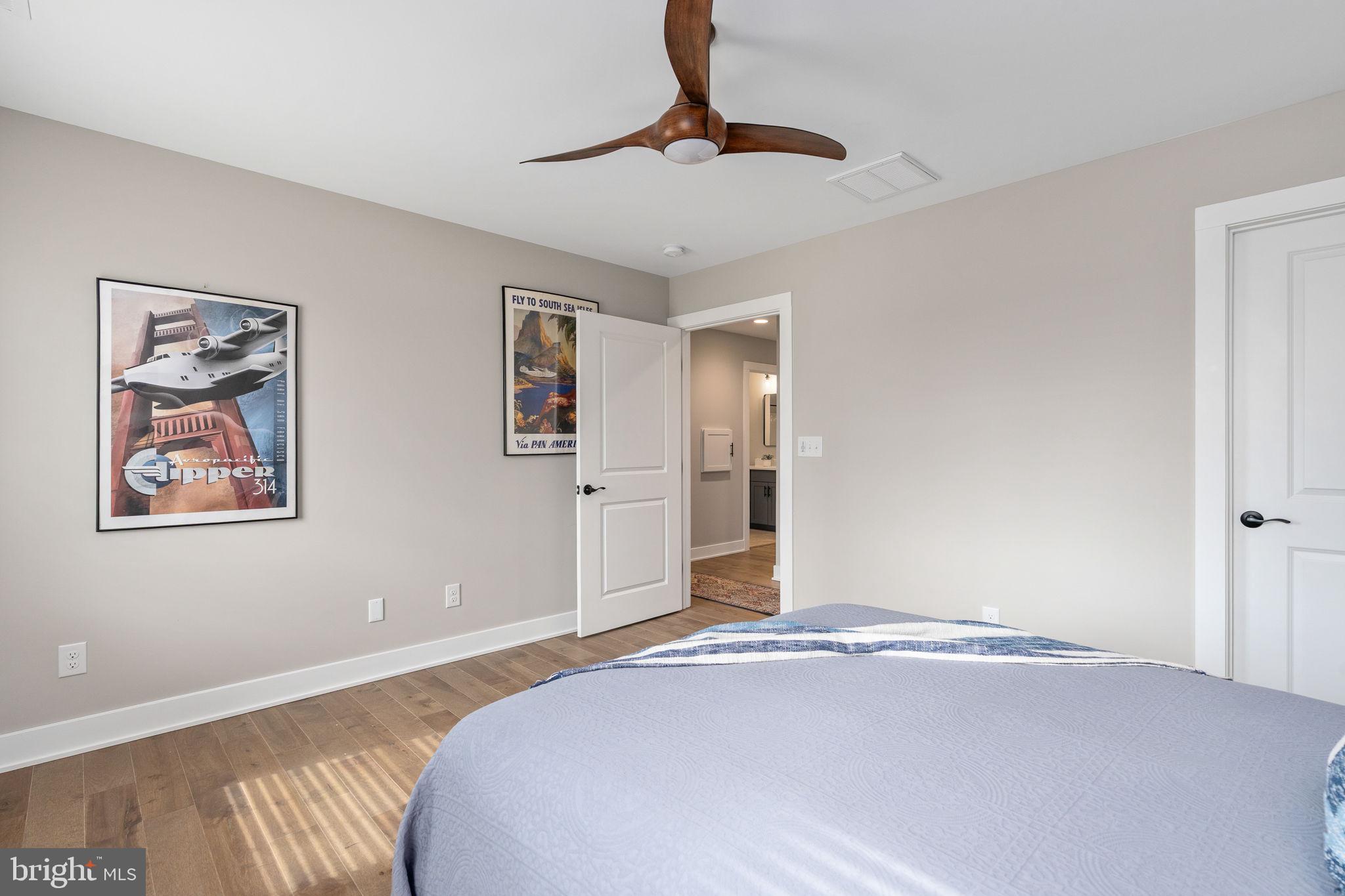261 Washington Street Locust Grove, VA 22508 - Photo 42 of 90 a bedroom with a bed and a painting on the wall