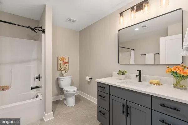 an aerial view of a house with a garden and lake view