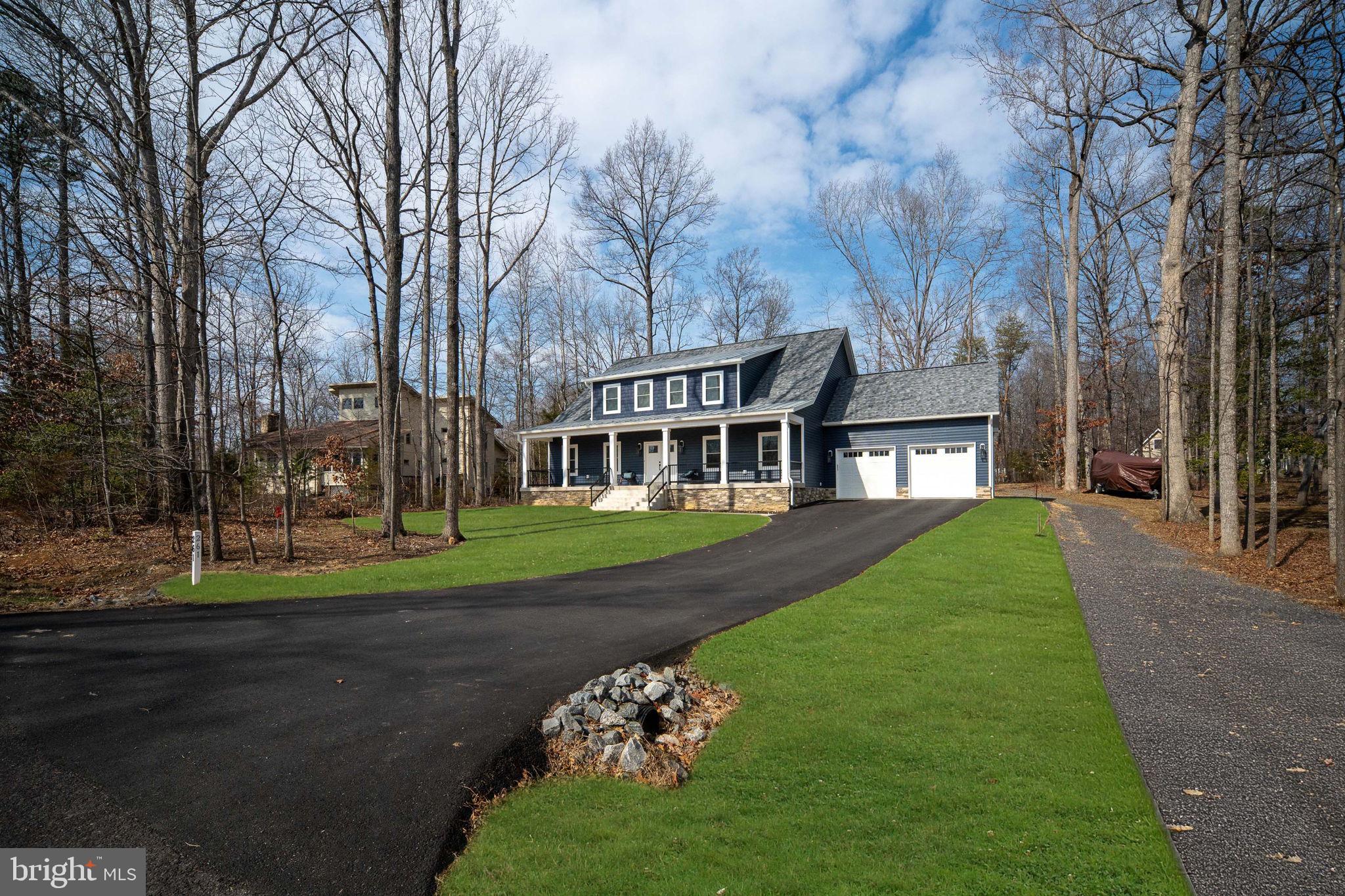 261 Washington Street Locust Grove, VA 22508 - Photo 52 of 90 a view of a brick house next to a yard with big trees