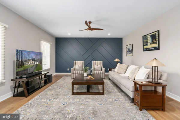 a living room with furniture and wooden floor