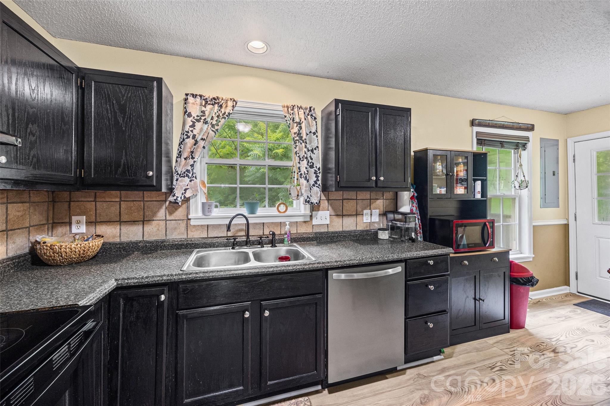 30 7th Street York, SC 29745 - Photo 8 of 29 a kitchen with stainless steel appliances granite countertop a sink stove and refrigerator