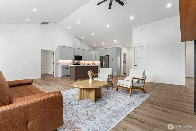 a living room with furniture and a wooden floor