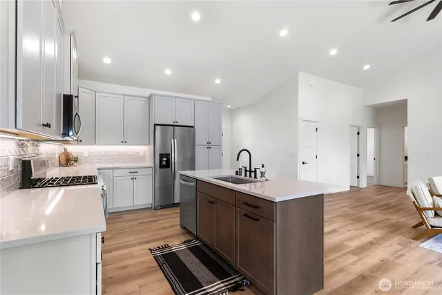a kitchen with a sink stainless steel appliances and cabinets