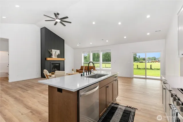 a kitchen with a sink appliances and living room