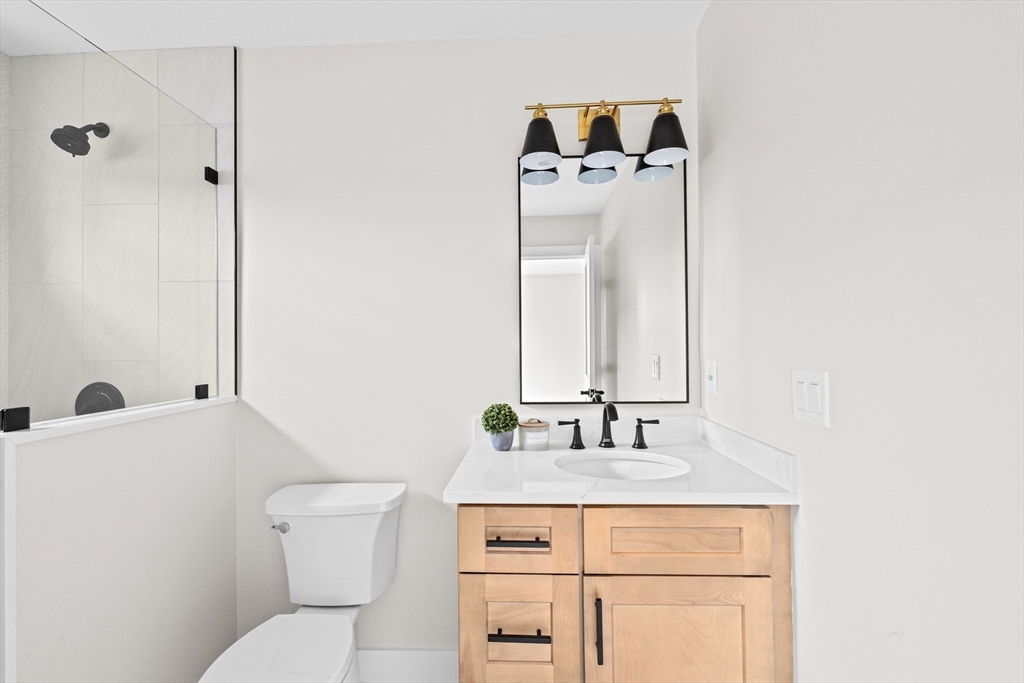 19 Ford Place, Unit 1 Scituate, MA 02066 - Photo 20 of 35 a bathroom with a sink toilet and mirror