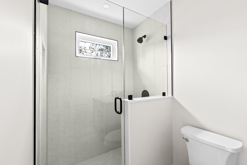 19 Ford Place, Unit 1 Scituate, MA 02066 - Photo 21 of 35 a bathroom with a shower a toilet and a sink