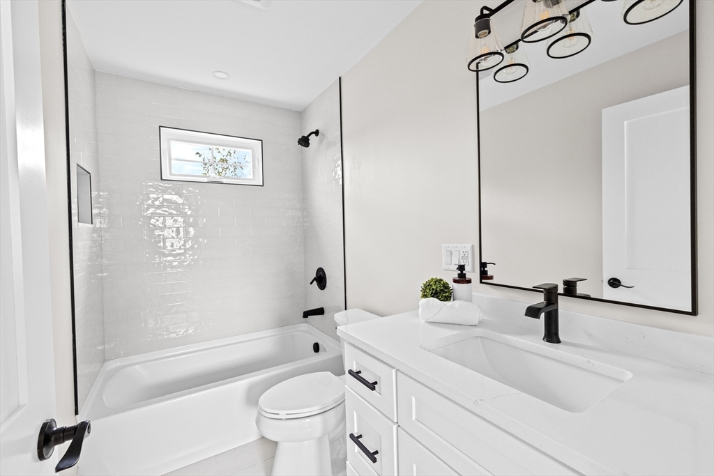 19 Ford Place, Unit 1 Scituate, MA 02066 - Photo 24 of 35 a bathroom with a sink a toilet and a mirror