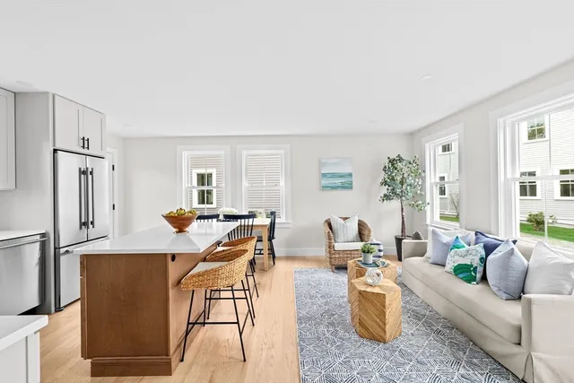 a living room with furniture windows and a refrigerator