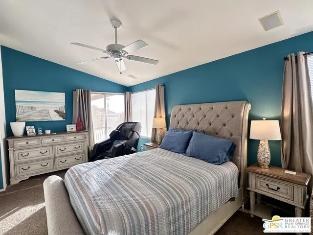 a bedroom with bed and window with lamp