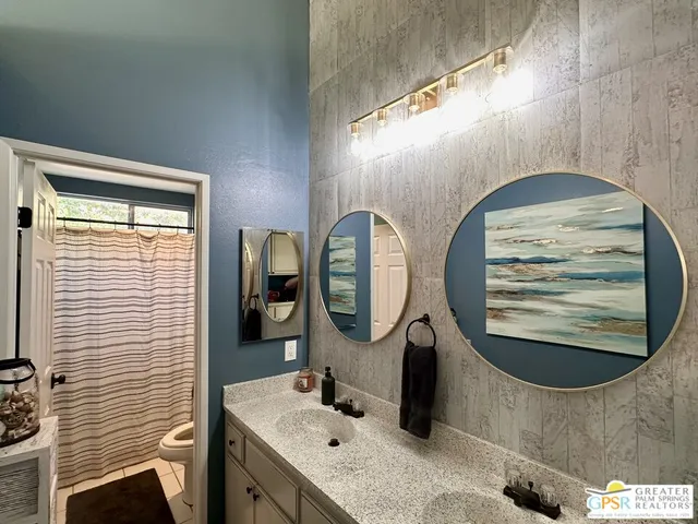 a bathroom with a sink mirror and tub