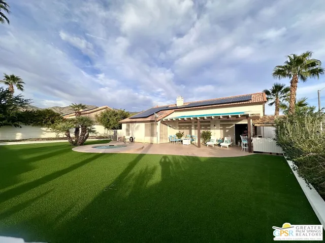 a view of yard with swimming pool and green space