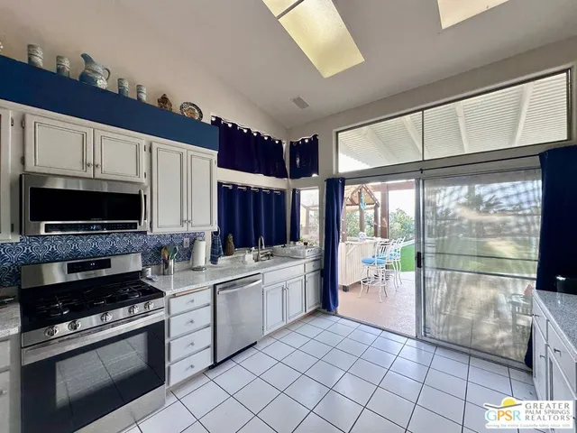 a kitchen with a stove a sink and a microwave