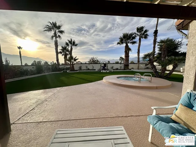 a view of a swimming pool and a yard