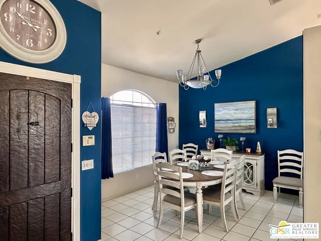 a dining room with furniture a rug and a chandelier